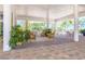 Exterior view showcasing an outdoor lounge with wicker chairs and tropical greenery creating a serene atmosphere at 8413 Placida Rd # 205, Placida, FL 33946
