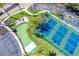 Aerial view of tennis courts and parking, offering residents recreational opportunities at 8413 Placida Rd # 205, Placida, FL 33946