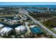 Aerial view of the community with tennis courts, a pool, and beautiful landscaping in coastal setting at 8500 Amberjack Cir # 102, Englewood, FL 34224