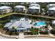 Community pool and clubhouse area, offering residents a luxurious and convenient recreational space, complete with water views and lush landscape at 8500 Amberjack Cir # 102, Englewood, FL 34224