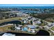 Overhead view of community featuring a pool, clubhouse, water features, and meticulously maintained landscaping at 8500 Amberjack Cir # 102, Englewood, FL 34224