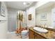Bathroom featuring a granite vanity, a shower with a palm tree curtain, and tile flooring at 8500 Amberjack Cir # 102, Englewood, FL 34224