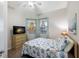This bedroom features seaside decor, a dresser, and a ceiling fan at 8500 Amberjack Cir # 102, Englewood, FL 34224