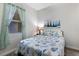 Bedroom with seaside themed bedspread, window with curtain, and a bedside table at 8500 Amberjack Cir # 102, Englewood, FL 34224