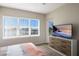 Bedroom with a large window offering plenty of natural light and a mounted television at 8500 Amberjack Cir # 102, Englewood, FL 34224