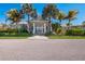 Elegant clubhouse featuring a welcoming entrance, lush landscaping, and convenient access for residents and their guests at 8500 Amberjack Cir # 102, Englewood, FL 34224