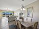 Dining area with seating for six and large sliding door overlooking the lanai at 8500 Amberjack Cir # 102, Englewood, FL 34224