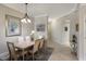 Dining room featuring a table with seating for six and a decorative light fixture at 8500 Amberjack Cir # 102, Englewood, FL 34224