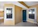 Inviting front entrance with a blue door, windows, and beige exterior at 8500 Amberjack Cir # 102, Englewood, FL 34224
