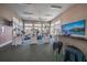 Bright fitness center with modern equipment, ceiling fans, and many windows offering natural light at 8500 Amberjack Cir # 102, Englewood, FL 34224