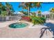 Community hot tub surrounded by lush landscaping and a gazebo in a tropical setting at 8500 Amberjack Cir # 102, Englewood, FL 34224