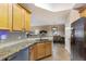 Kitchen features stainless steel appliances, granite countertops, and a view into the dining room at 8500 Amberjack Cir # 102, Englewood, FL 34224