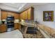 Well-lit kitchen with granite countertops, stainless steel appliances, and ample cabinet space at 8500 Amberjack Cir # 102, Englewood, FL 34224