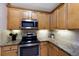 Granite countertops, stainless steel appliances and light wood cabinets are featured in this kitchen at 8500 Amberjack Cir # 102, Englewood, FL 34224