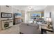 Cozy living room with large windows and access to an outdoor balcony area at 8500 Amberjack Cir # 102, Englewood, FL 34224