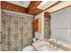 Bathroom featuring a wooden ceiling, shower with a floral curtain, and mirrored cabinets at 9149 Castlehill Ave, Englewood, FL 34224
