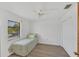 Bright bedroom with a twin bed, ceiling fan and window at 9149 Castlehill Ave, Englewood, FL 34224