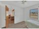 Bright bedroom with a twin bed, ceiling fan and a view to the Living Room at 9149 Castlehill Ave, Englewood, FL 34224