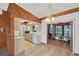 Bright kitchen featuring wood cabinets, tile floors, and an open layout to the dining area at 9149 Castlehill Ave, Englewood, FL 34224