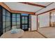Bright sunroom features wood ceiling beams, tiled floors, and expansive windows, offering lots of natural light at 9149 Castlehill Ave, Englewood, FL 34224