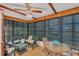 A sunroom with tile flooring, wood ceiling and many windows at 9149 Castlehill Ave, Englewood, FL 34224