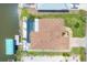 Aerial view of property with pool, dock, and canal access at 9574 Arsipe Cir, Port Charlotte, FL 33981