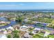 Beautiful aerial view of waterfront homes along canals leading to the ocean under a clear blue sky at 9574 Arsipe Cir, Port Charlotte, FL 33981
