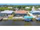 Aerial view of property with a waterfront location, pool, and boat dock at 9574 Arsipe Cir, Port Charlotte, FL 33981