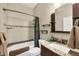 Cozy bathroom featuring a shower-tub combo with marble tile surround, and a granite countertop vanity at 9574 Arsipe Cir, Port Charlotte, FL 33981