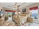 Elegant main bedroom with four-poster bed, tray ceiling, and sliding glass doors to outdoor living space at 9574 Arsipe Cir, Port Charlotte, FL 33981