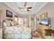 Spacious main bedroom featuring a tray ceiling, elegant decor, and neutral walls with tile floors at 9574 Arsipe Cir, Port Charlotte, FL 33981