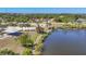 A pier extends into a serene lake, complemented by a covered picnic area, perfect for outdoor enjoyment at 9574 Arsipe Cir, Port Charlotte, FL 33981