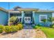 Welcoming entrance with double doors, decorative wreaths, and manicured landscaping at 9574 Arsipe Cir, Port Charlotte, FL 33981