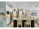 Modern kitchen with island, granite counters, stainless steel appliances, and pendant lighting at 9574 Arsipe Cir, Port Charlotte, FL 33981