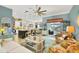 Open-concept living area with modern furnishings and views of the kitchen and waterfront at 9574 Arsipe Cir, Port Charlotte, FL 33981
