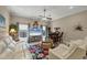 Comfortable living room featuring a ceiling fan and a decorative rug at 9574 Arsipe Cir, Port Charlotte, FL 33981