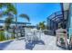 Outdoor patio area with dining set, overlooking the canal and boat dock at 9574 Arsipe Cir, Port Charlotte, FL 33981