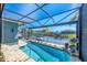 Beautiful pool and spa, screened in with a lanai, overlooking a tranquil canal with lush landscaping at 9574 Arsipe Cir, Port Charlotte, FL 33981