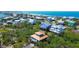 Expansive aerial view of colorful coastal homes, showcasing a vibrant community near the ocean at 9580 Almirate Ct, Placida, FL 33946