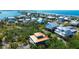 Picturesque aerial view of coastal homes near the ocean, showcasing a vibrant community at 9580 Almirate Ct, Placida, FL 33946