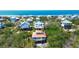 Stunning aerial view of colorful beach homes, ideal for coastal living and serene landscapes at 9580 Almirate Ct, Placida, FL 33946
