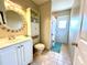 Bathroom with a vanity, mirror, linen closet, and walk-out door to the exterior at 9580 Almirate Ct, Placida, FL 33946