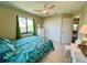 Bedroom with tiled floors, two windows with green curtains, and a decorative bedspread at 9580 Almirate Ct, Placida, FL 33946