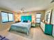 A bedroom featuring an aqua blue headboard and a dresser with a mirror at 9580 Almirate Ct, Placida, FL 33946