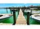 Scenic view of a boat dock showcasing docked boats and serene waterfront property at 9580 Almirate Ct, Placida, FL 33946