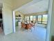 Bright dining room featuring large windows with views and seating for six around a glass table at 9580 Almirate Ct, Placida, FL 33946