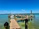 Picturesque dock on clear waters with boats moored, reflecting a serene waterfront lifestyle at 9580 Almirate Ct, Placida, FL 33946