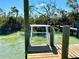 View of wooden dock with sturdy support posts, offering access to serene waterfront area at 9580 Almirate Ct, Placida, FL 33946
