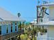 Scenic exterior view of coastal homes near clear ocean waters, highlighting the serene beachside atmosphere at 9580 Almirate Ct, Placida, FL 33946