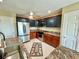 Updated kitchen with stainless steel appliances, custom cabinets, and stone countertops at 9580 Almirate Ct, Placida, FL 33946